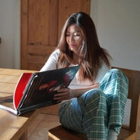 Woman wearing mint tartan plaid cotton oxford short length pyjama bottoms in kitchen